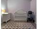 Cozy Bedroom with a white crib, changing table, and accent rug at 6421 Banyan Blvd # 302, New Port Richey, FL 34652