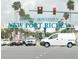 Historic downtown New Port Richey sign with bustling traffic and palm trees, showcasing a vibrant city scene at 6421 Banyan Blvd # 302, New Port Richey, FL 34652