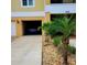 Garage and front yard with palm tree at 6421 Banyan Blvd # 302, New Port Richey, FL 34652