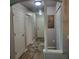 Hallway with neutral paint, wood floors, and multiple doors at 6421 Banyan Blvd # 302, New Port Richey, FL 34652