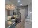 Stylish eat-in kitchen with stainless steel appliances and gorgeous pendant lighting at 6421 Banyan Blvd # 302, New Port Richey, FL 34652
