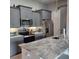 This kitchen offers gray cabinets, stainless steel appliances, and marble countertops at 6421 Banyan Blvd # 302, New Port Richey, FL 34652