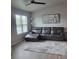 Comfortable living room with neutral walls and a large gray sectional sofa at 6421 Banyan Blvd # 302, New Port Richey, FL 34652