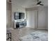 Bright living room with luxury vinyl plank flooring and a modern entertainment center at 6421 Banyan Blvd # 302, New Port Richey, FL 34652