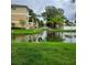 Picturesque pond view surrounded by lush greenery and community buildings at 6421 Banyan Blvd # 302, New Port Richey, FL 34652