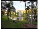 Serene pond with a fountain, surrounded by lush landscaping and residential buildings in the background at 6421 Banyan Blvd # 302, New Port Richey, FL 34652