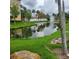 Picturesque pond view surrounded by lush greenery and a water fountain at 6421 Banyan Blvd # 302, New Port Richey, FL 34652
