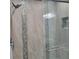 Elegant tiled shower featuring dual shower heads and decorative mosaic accents at 6421 Banyan Blvd # 302, New Port Richey, FL 34652