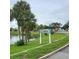 Sign indicating a private beach for members only, overlooking a serene pond surrounded by lush greenery at 6421 Banyan Blvd # 302, New Port Richey, FL 34652