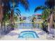 Community spa and water feature overlooking a tranquil pond, framed by lush palm trees and inviting residences at 6421 Banyan Blvd # 302, New Port Richey, FL 34652