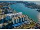 Expansive aerial view showcasing waterfront condos with boat docks, coastal city and sparkling water at 690 Island Way # 404, Clearwater Beach, FL 33767
