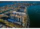 Wide aerial view of waterfront condos surrounded by boats, homes, and clear blue water at 690 Island Way # 404, Clearwater Beach, FL 33767