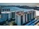 Stunning aerial view of modern condos with boat docks, coastal city, and bright blue water at 690 Island Way # 404, Clearwater Beach, FL 33767
