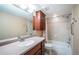 Well-lit bathroom features a vanity with cabinets and drawers, tub-shower combo, and tiled walls at 690 Island Way # 404, Clearwater Beach, FL 33767