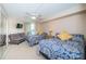 Bright bedroom with two beds, ceiling fan, and sliding glass doors leading to a balcony with water views at 690 Island Way # 404, Clearwater Beach, FL 33767