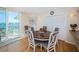 Cozy dining area with a round table and chairs, featuring water views through a sliding glass door at 690 Island Way # 404, Clearwater Beach, FL 33767