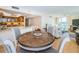 Open concept dining area with wood table adjacent to the kitchen and living room at 690 Island Way # 404, Clearwater Beach, FL 33767