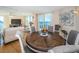 Open concept dining room area featuring a round wood table, six chairs and water views at 690 Island Way # 404, Clearwater Beach, FL 33767