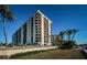 Beautiful condominium building featuring multiple balconies and inviting landscaping at 690 Island Way # 404, Clearwater Beach, FL 33767
