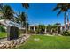 Beautiful Island West Grill with lush landscaping, decorative fountain, and palm trees at 690 Island Way # 404, Clearwater Beach, FL 33767