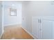 Hallway features hardwood floors and additional storage with white cabinets at 690 Island Way # 404, Clearwater Beach, FL 33767