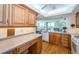 Kitchen featuring wooden cabinetry, countertops, and hardwood floors, with an open view to living area at 690 Island Way # 404, Clearwater Beach, FL 33767