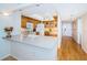 Bright kitchen with wooden cabinets, neutral countertops, recessed lighting, and a breakfast bar at 690 Island Way # 404, Clearwater Beach, FL 33767