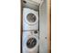 Convenient in-unit laundry closet featuring a stacked Samsung washer and dryer at 690 Island Way # 404, Clearwater Beach, FL 33767
