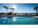 Waterfront pool with lounge chairs, palm trees, and dock access at 690 Island Way # 404, Clearwater Beach, FL 33767