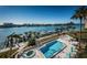 Waterfront community pool with lounge chairs and a scenic view of the bay at 690 Island Way # 404, Clearwater Beach, FL 33767