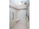 Modern shower with dual showerheads, grab bar, tiled walls with accent border, and a built-in corner seat at 690 Island Way # 404, Clearwater Beach, FL 33767