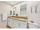 Bathroom with a double vanity, granite countertops, framed mirrors and tile floors at 7245 Wood Creek Dr # 29, Sarasota, FL 34231