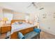 Bright bedroom with a ceiling fan, bedside tables with lamps, and a bench at the foot of the wood bed frame at 7245 Wood Creek Dr # 29, Sarasota, FL 34231