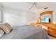 Cozy bedroom featuring a ceiling fan, dresser with mirror, and a comfortable-looking bed with a gray quilt at 7245 Wood Creek Dr # 29, Sarasota, FL 34231