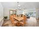 Elegant dining area with a wooden table, six chairs, and modern chandelier at 7245 Wood Creek Dr # 29, Sarasota, FL 34231