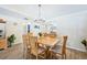 Bright dining room featuring wood floors, a chandelier, and seating for six around a wood table at 7245 Wood Creek Dr # 29, Sarasota, FL 34231