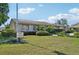 Exterior view of a community clubhouse and pool with a manicured lawn at 7245 Wood Creek Dr # 29, Sarasota, FL 34231