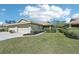 The well-manicured lawn and tidy landscaping enhance the curb appeal of this beige one-story home at 7245 Wood Creek Dr # 29, Sarasota, FL 34231