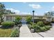 Charming single-story home with lush front yard landscaping and sidewalk at 7245 Wood Creek Dr # 29, Sarasota, FL 34231