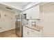 Kitchen featuring stainless steel refrigerator, granite countertops, and white cabinets at 7245 Wood Creek Dr # 29, Sarasota, FL 34231