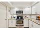 Kitchen featuring granite countertops, stainless steel oven range, white cabinets, and recessed lighting at 7245 Wood Creek Dr # 29, Sarasota, FL 34231