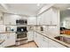 Well-lit kitchen with granite countertops, white subway tile backsplash, and stainless steel appliances at 7245 Wood Creek Dr # 29, Sarasota, FL 34231
