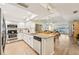 Open concept kitchen with granite countertops, stainless steel appliances, and views to the dining and living areas at 7245 Wood Creek Dr # 29, Sarasota, FL 34231