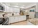 Bright kitchen featuring granite countertops, white cabinets, and stainless steel appliances at 7245 Wood Creek Dr # 29, Sarasota, FL 34231