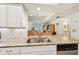 Granite countertops with a stainless steel double sink are shown in this bright kitchen at 7245 Wood Creek Dr # 29, Sarasota, FL 34231