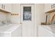 Functional laundry room featuring a washer, dryer, and extra storage, providing convenience for daily chores at 7245 Wood Creek Dr # 29, Sarasota, FL 34231