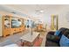 Bright living room with a large entertainment center, comfortable seating, and elegant decor at 7245 Wood Creek Dr # 29, Sarasota, FL 34231