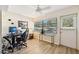 Home office with a modern desk, comfortable chair, large window and door, and a ceiling fan at 7245 Wood Creek Dr # 29, Sarasota, FL 34231