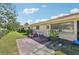 Home's backyard patio featuring brick pavers, chair, and tropical landscaping at 7245 Wood Creek Dr # 29, Sarasota, FL 34231
