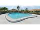 A refreshing view of the community swimming pool with clear blue water and mature landscaping at 7245 Wood Creek Dr # 29, Sarasota, FL 34231